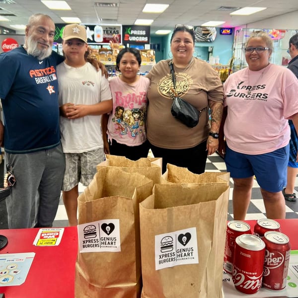 Five people pose inside Xpress Burgers beside branded takeout bags, soft drinks, and a restaurant counter.