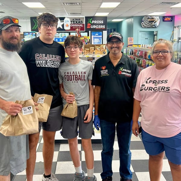 Five people, including Xpress Burgers staff, stand in a store holding brown paper bags with logos.